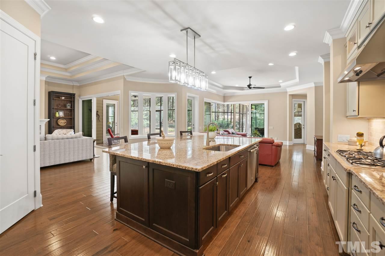1504 Brassfield Road Raleigh, NC 27614 - Photo 4 of 30 a large kitchen with stainless steel appliances granite countertop a lot of counter space and wooden floors