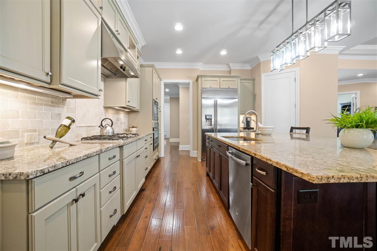 1504 Brassfield Road Raleigh, NC 27614 - Photo 5 of 30 a large kitchen with granite countertop a sink and cabinets