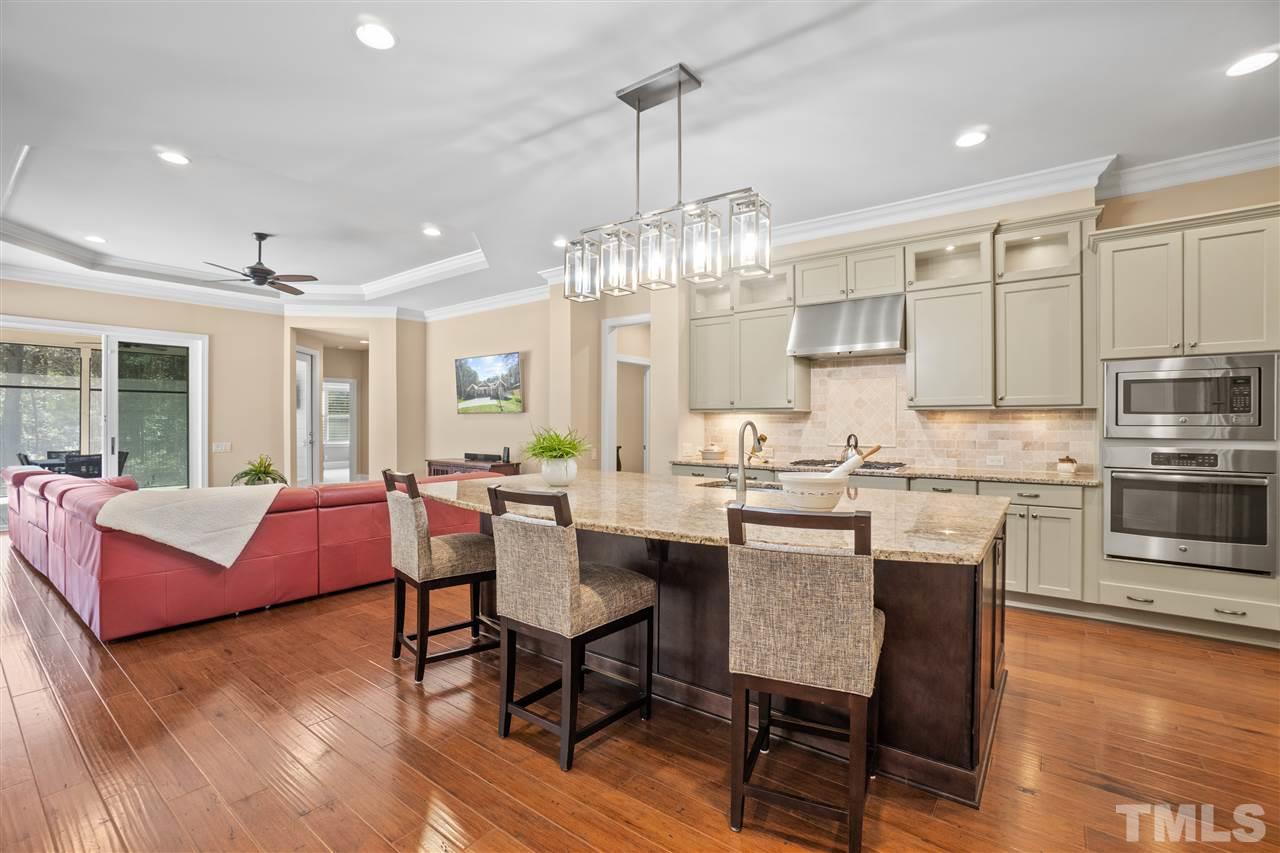1504 Brassfield Road Raleigh, NC 27614 - Photo 7 of 30 a view of kitchen with dining table chairs and wooden floor