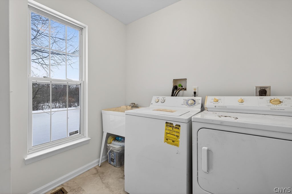 4848 Yenny Road Onondaga, NY 13215 - Photo 19 of 50 First floor laundry with wash tub and new flooring