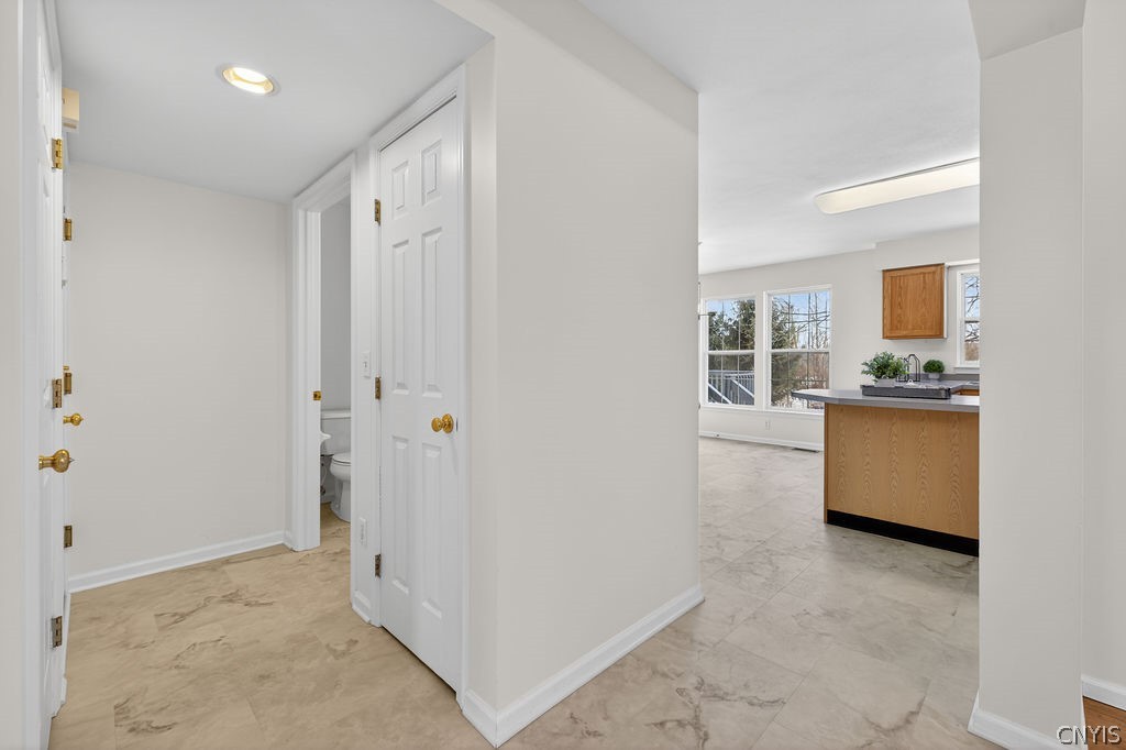 4848 Yenny Road Onondaga, NY 13215 - Photo 8 of 50 Hallway to the half bath, coat closet, lower level