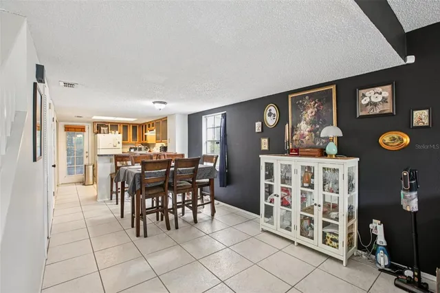 a view of a dining room with furniture and chandelier