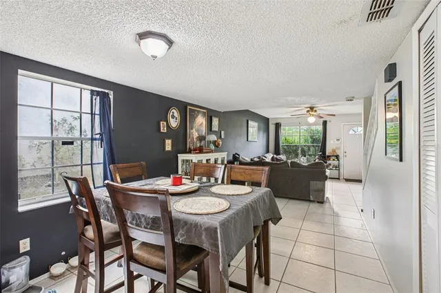 a dinning area with furniture and a view of kitchen