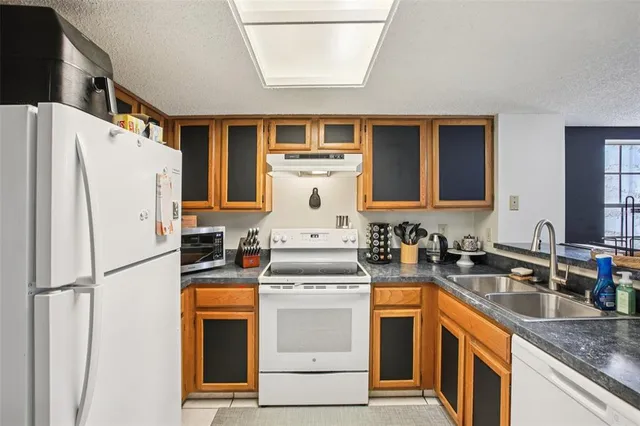 a kitchen with a stove a refrigerator and a sink
