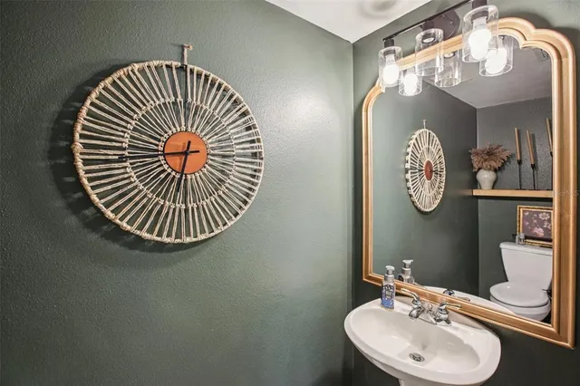 a bathroom with a sink a mirror and vanity