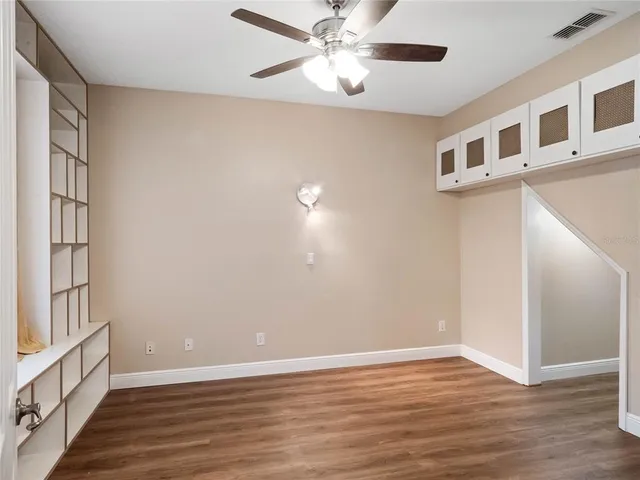 a view of a hallway with wooden floor and front door