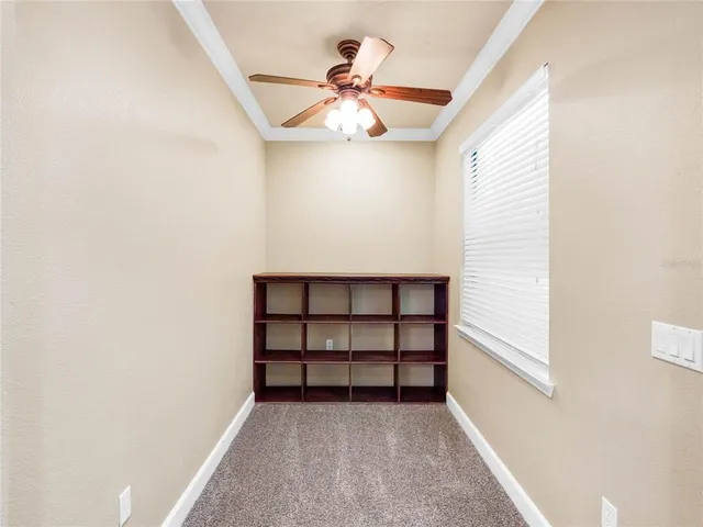 a aerial view of a house with a yard and large tree