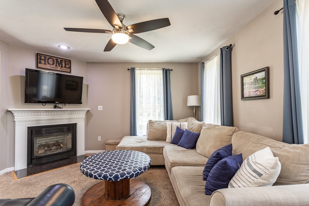 39 Nachaomet Road Lakeville, MA 02347 - Photo 8 of 42 a living room with furniture a fireplace and a flat screen tv