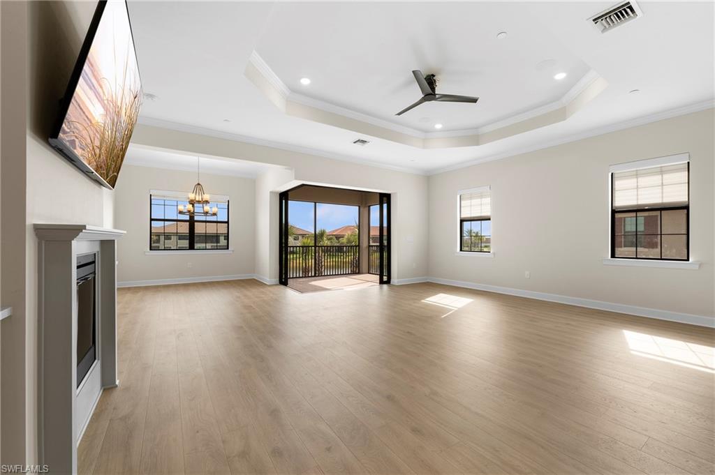 15327 Lucerna Street, Unit 204 Naples, FL 34114 - Photo 13 of 45 an empty room with windows and ceiling fan