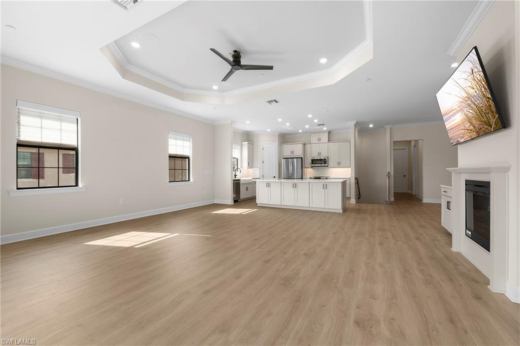 15327 Lucerna Street, Unit 204 Naples, FL 34114 - Photo 14 of 45 a view of empty room with wooden floor and window