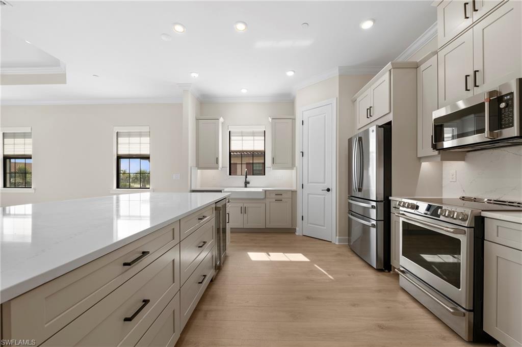 15327 Lucerna Street, Unit 204 Naples, FL 34114 - Photo 15 of 45 a kitchen with stainless steel appliances white cabinets and a refrigerator