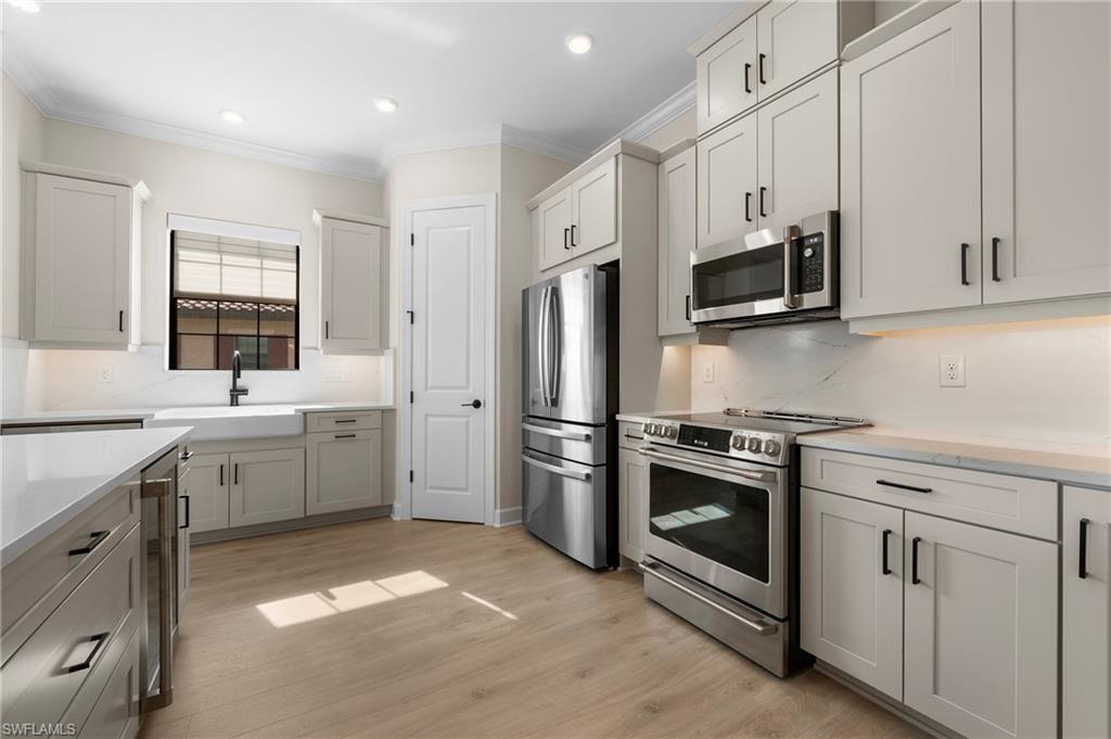 15327 Lucerna Street, Unit 204 Naples, FL 34114 - Photo 16 of 45 a kitchen with a sink stove and refrigerator