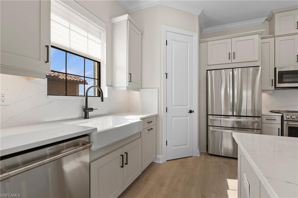 15327 Lucerna Street, Unit 204 Naples, FL 34114 - Photo 18 of 45 a kitchen with a refrigerator sink and microwave