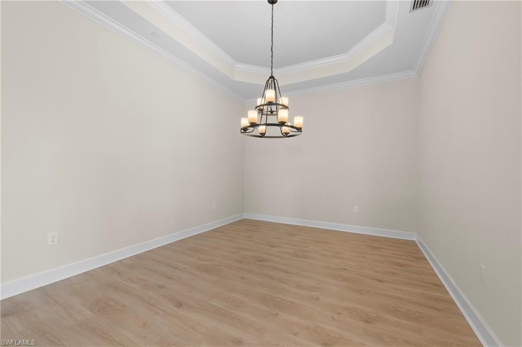 15327 Lucerna Street, Unit 204 Naples, FL 34114 - Photo 19 of 45 a picture of a room with a hanging light and kitchen