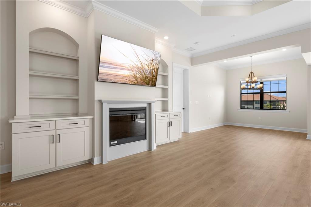 15327 Lucerna Street, Unit 204 Naples, FL 34114 - Photo 21 of 45 a view of empty room with a fireplace and wooden floor