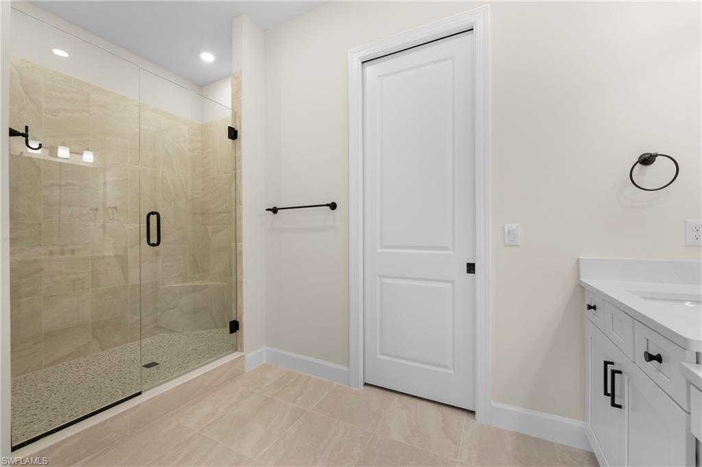 15327 Lucerna Street, Unit 204 Naples, FL 34114 - Photo 25 of 45 a bathroom with a shower and a sink