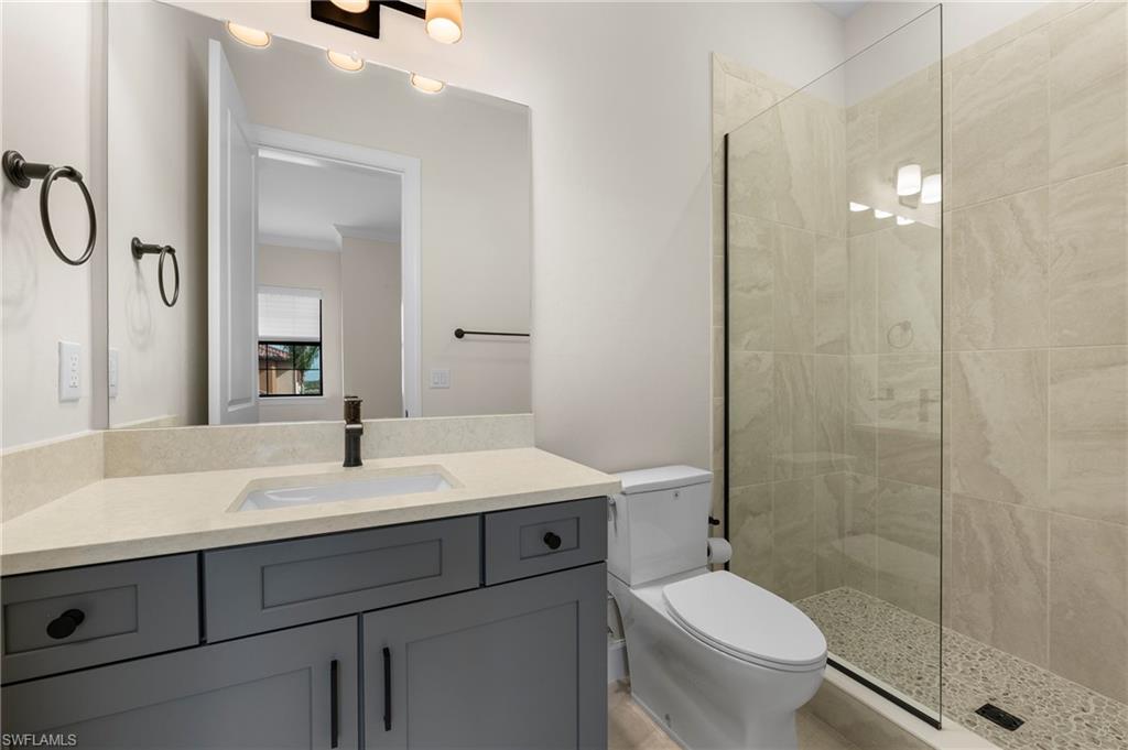 15327 Lucerna Street, Unit 204 Naples, FL 34114 - Photo 27 of 45 a bathroom with a sink a toilet and shower