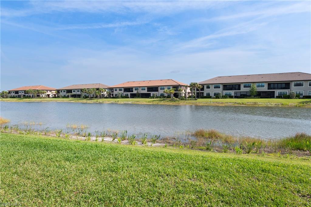 15327 Lucerna Street, Unit 204 Naples, FL 34114 - Photo 7 of 45 a view of a lake with houses in the back