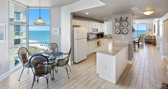 a kitchen with granite countertop a sink stainless steel appliances and a counter top space