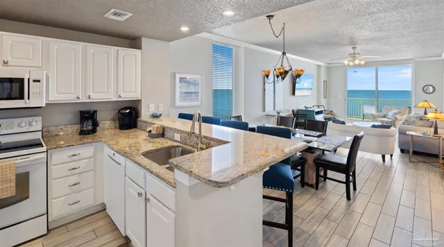 a view of a kitchen with furniture and wooden floor