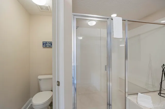 a bedroom with a large bed and wooden floor