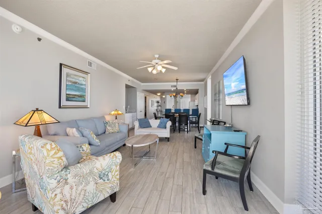 a living room with furniture a couch and wooden floor