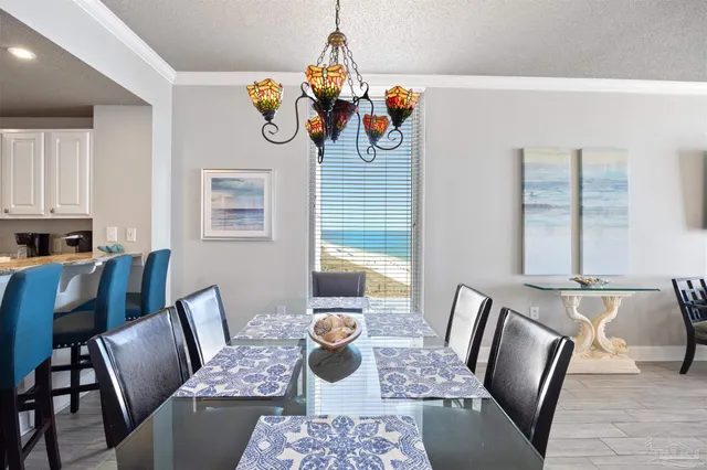 a kitchen with stainless steel appliances granite countertop a table chairs sink and cabinets