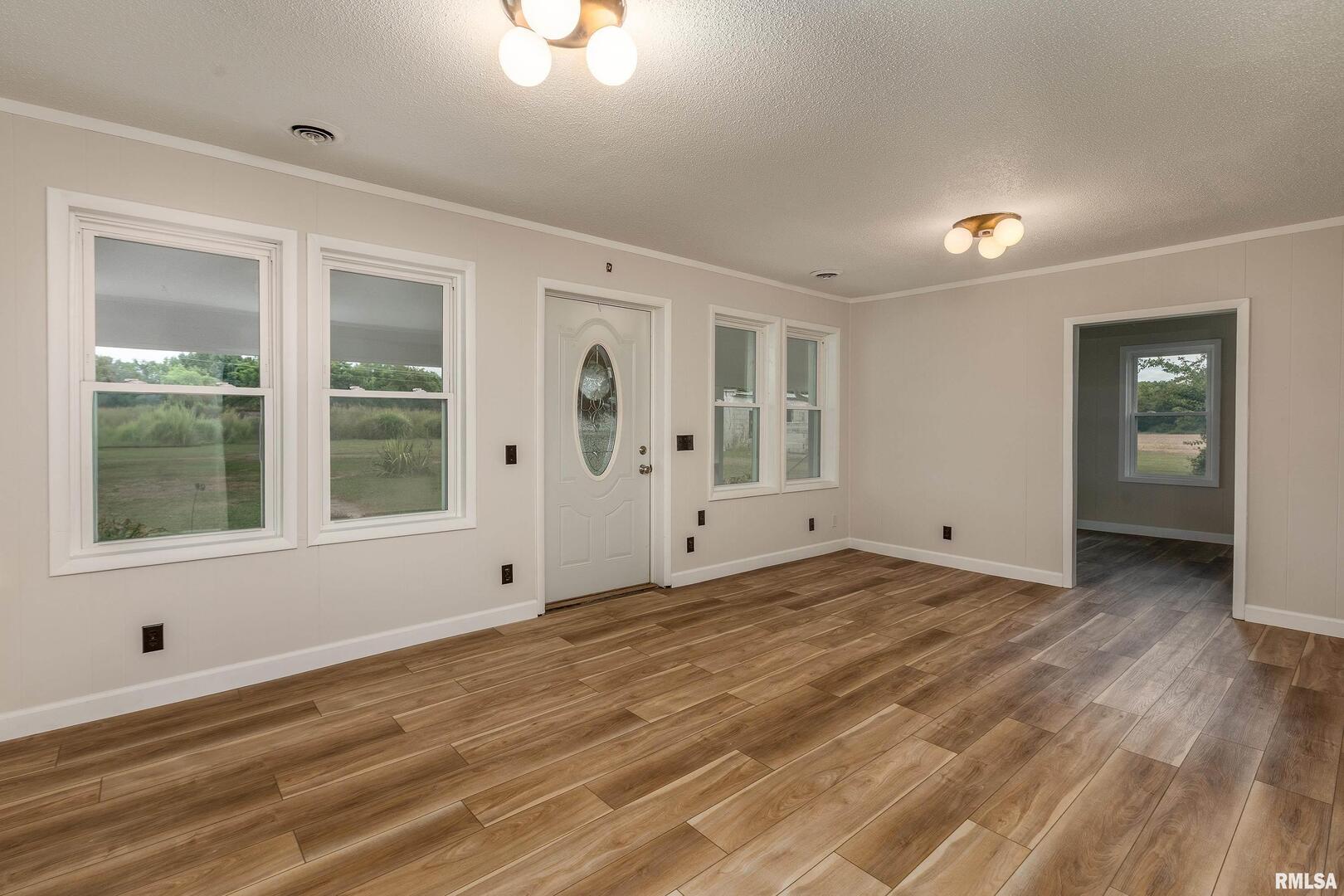 53 Private Road De Soto, IL 62924 - Photo 14 of 36 a view of empty room with window and wooden floor