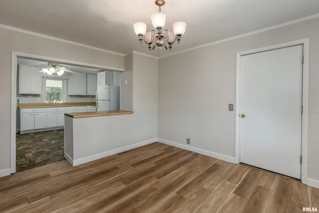 a view of a kitchen with a sink cabinets and wooden floor