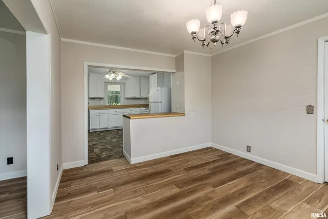 a view of a kitchen and a sink wooden floor chandelier