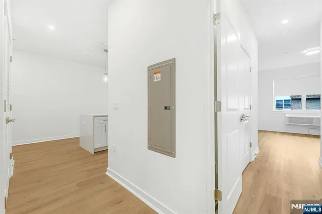 a view of a hallway with wooden floor