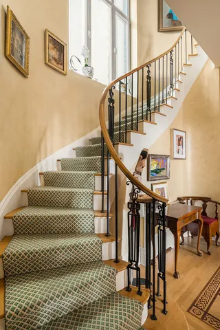 a view of an entryway with wooden floor and a chandelier