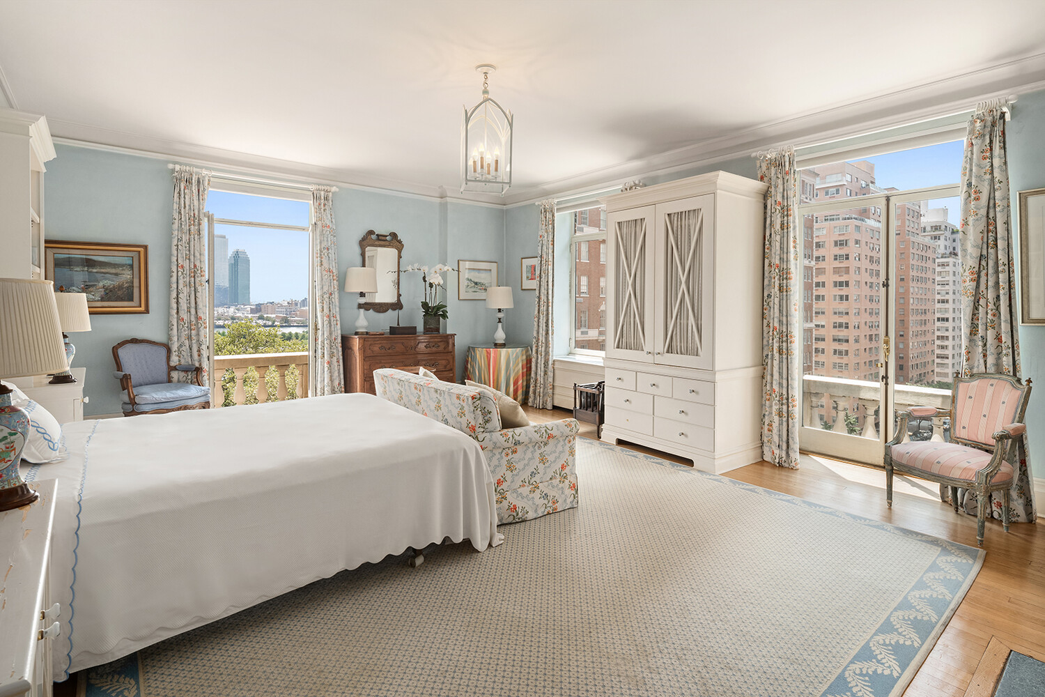 4 Sutton Place, Unit DUPLEX6/7 Manhattan, NY 10022 - Photo 14 of 19 a bedroom with a large bed and a chandelier