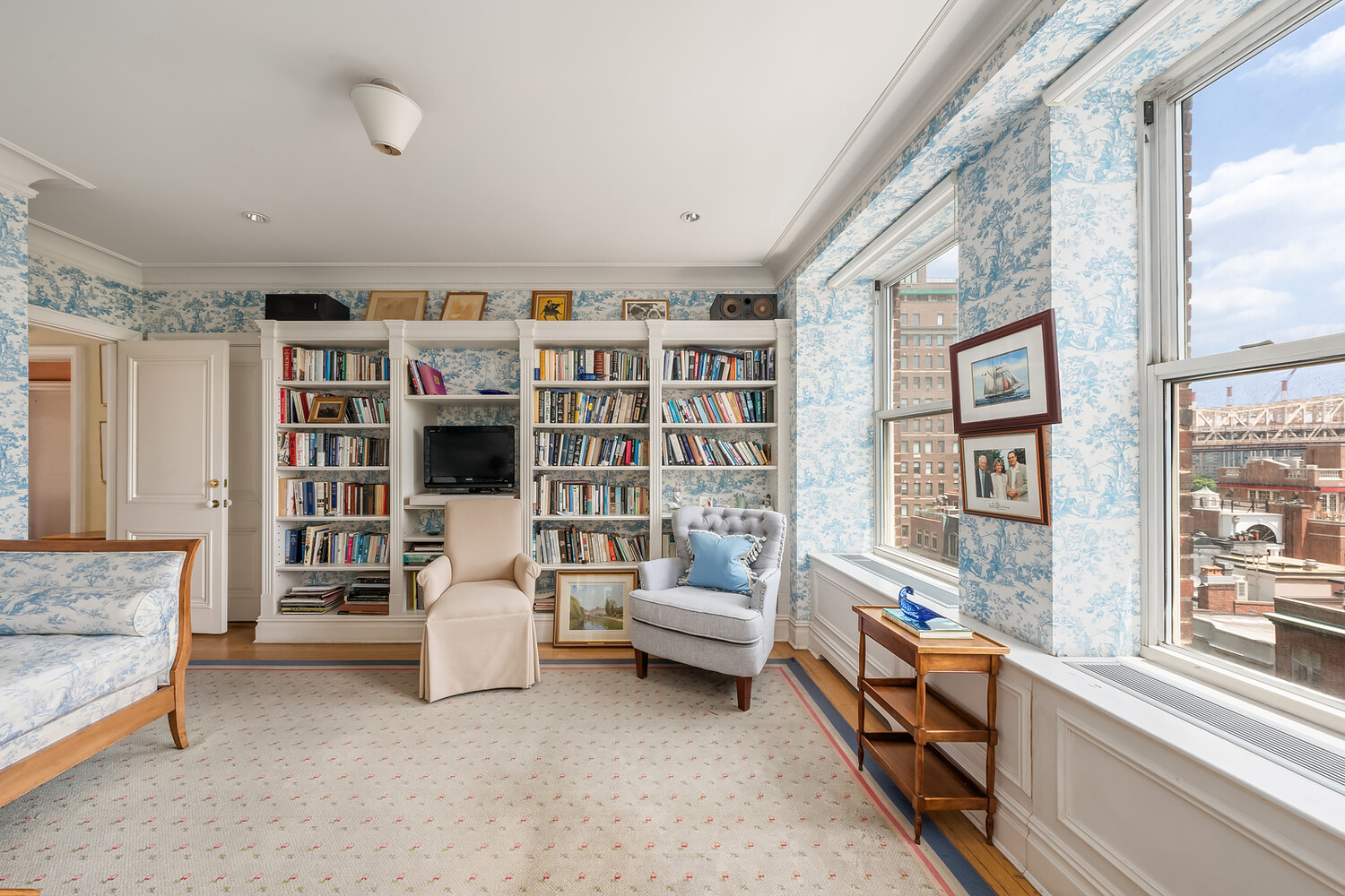 4 Sutton Place, Unit DUPLEX6/7 Manhattan, NY 10022 - Photo 18 of 19 a living room with furniture and large windows