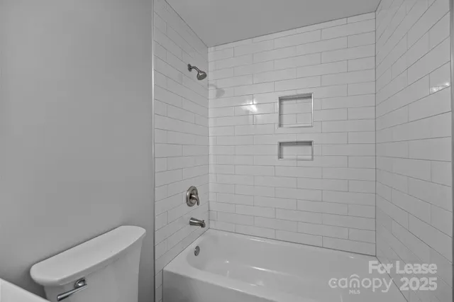 a bathroom with a bathtub and shower