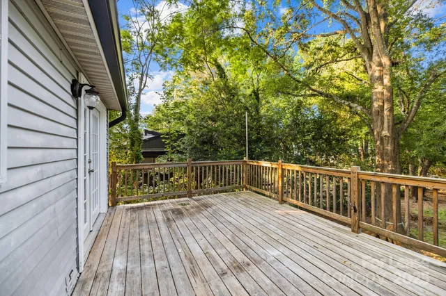 a view of balcony with wooden floor and fence