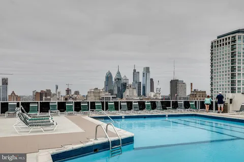 a view of a swimming pool with outdoor seating and a lake view