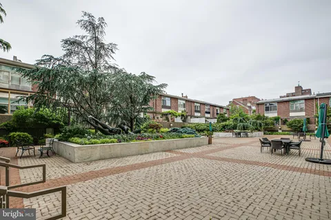 a wooden bench sitting in front of a building