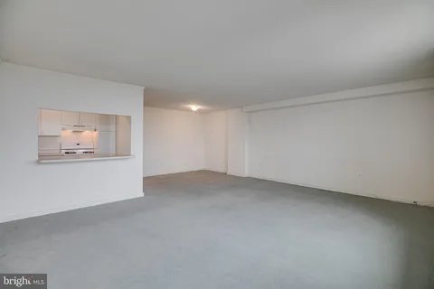 a view of an empty room with a painting on the wall