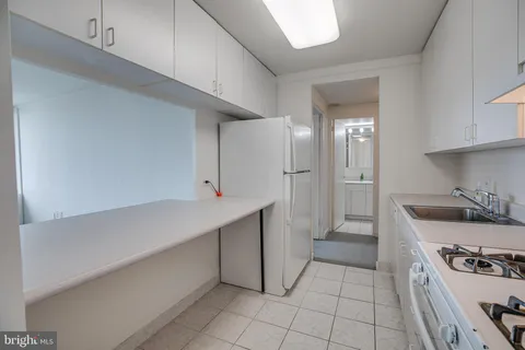 a kitchen with a stove and a refrigerator