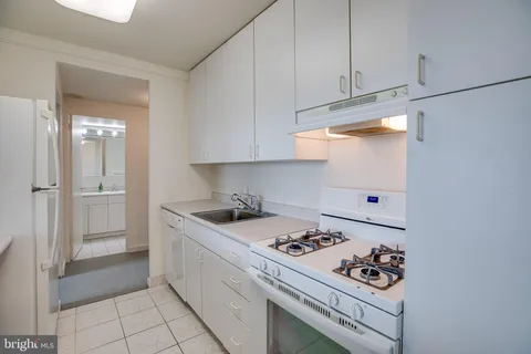 a kitchen with a stove and a refrigerator