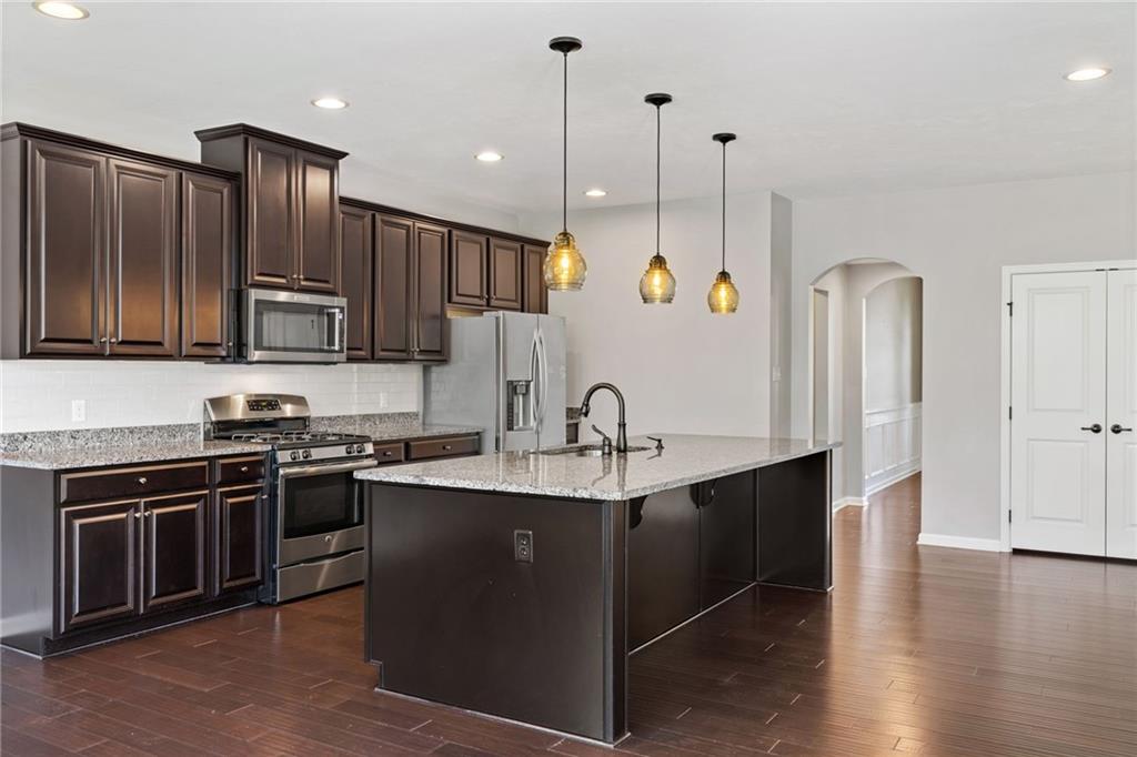 207 Gabriel Drive Mars, PA 16046 - Photo 14 of 47 a kitchen with stainless steel appliances granite countertop a sink a stove a refrigerator cabinets and wooden floor