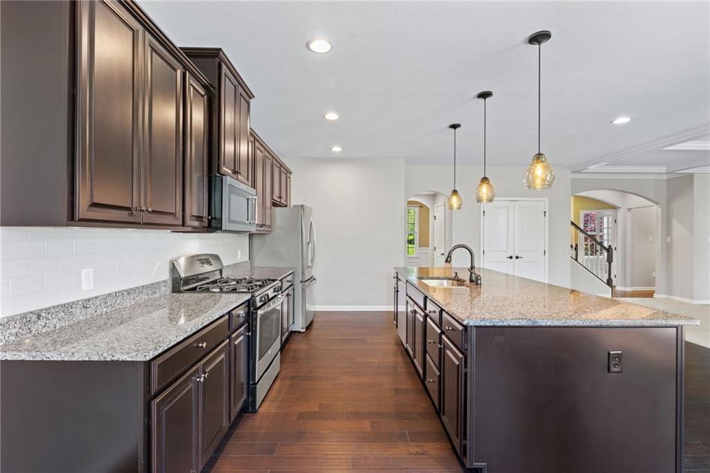 207 Gabriel Drive Mars, PA 16046 - Photo 17 of 47 a kitchen with stainless steel appliances granite countertop a sink a stove oven a refrigerator with wooden cabinets