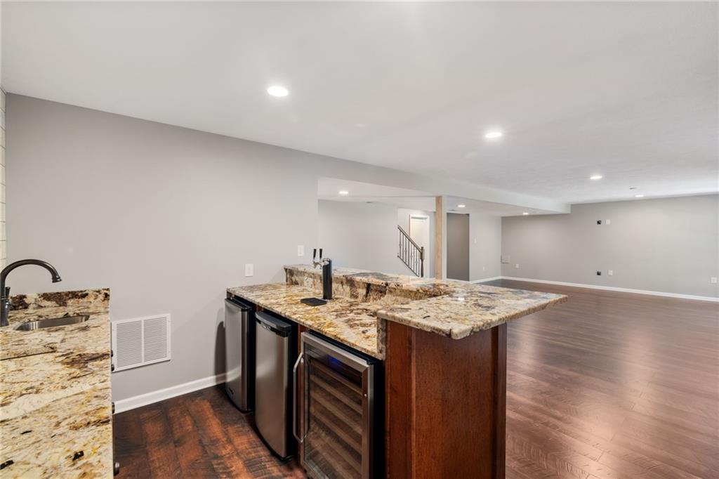 207 Gabriel Drive Mars, PA 16046 - Photo 34 of 47 a kitchen that has a sink a stove and a wooden floor