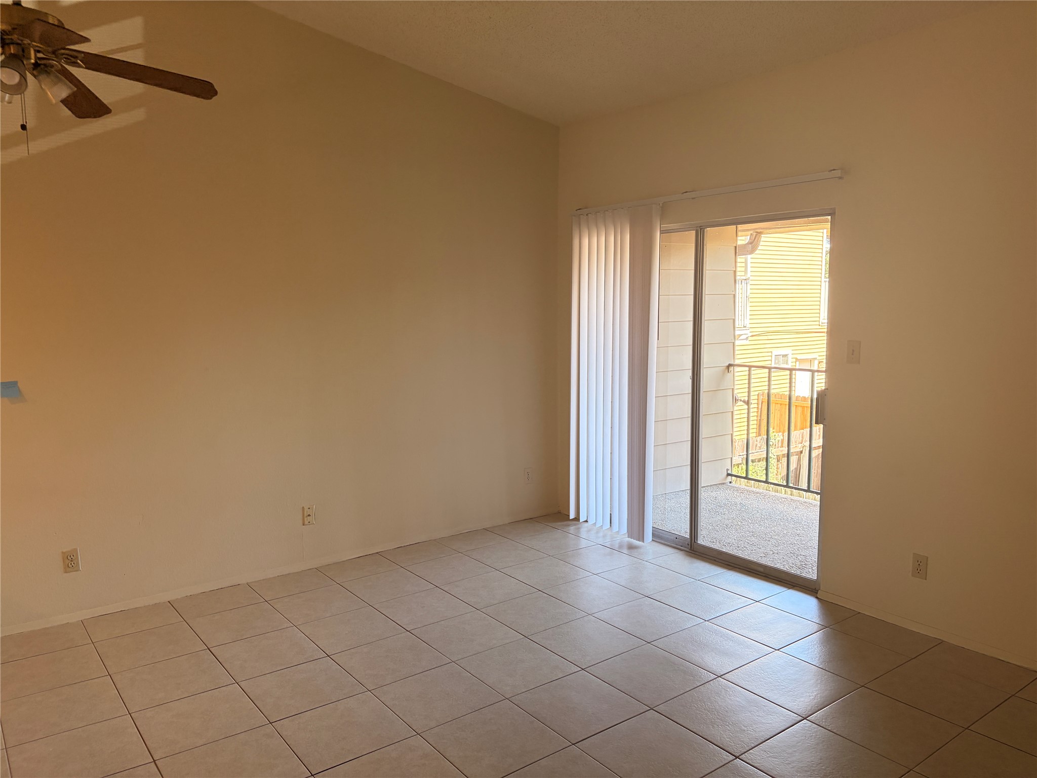 630 Maiden Lane, Unit G Austin, TX 78705 - Photo 3 of 3 Spacious interior featuring tile flooring, vaulted ceilings, and a ceiling fan with integrated lighting