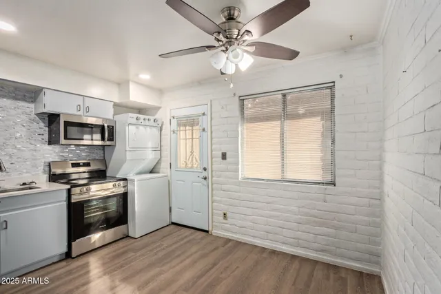 a kitchen with white cabinets and white appliances