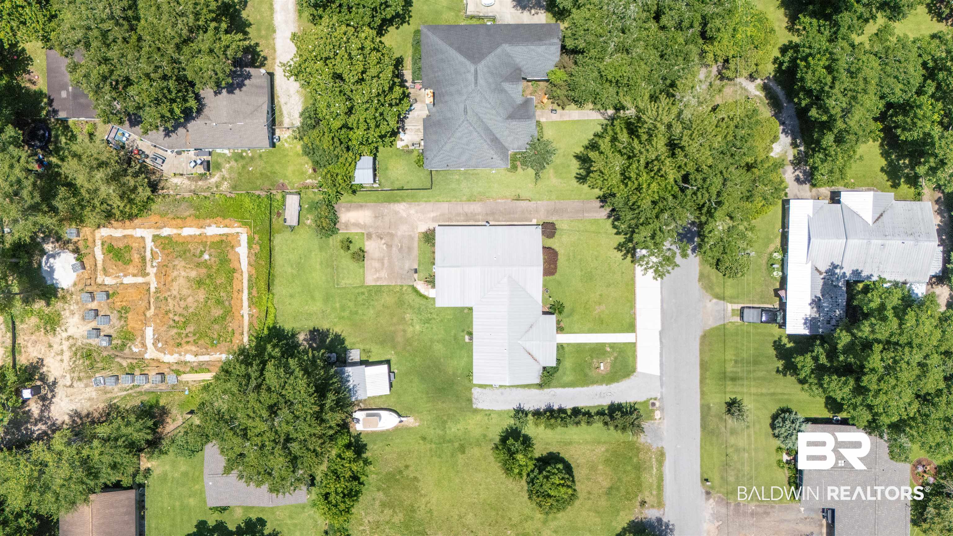 1615 5th Street Daphne, AL 36526 - Photo 28 of 28 Aerial perspective showcasing a parcel with established trees and a cleared building site
