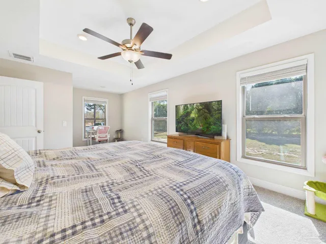 a bedroom with a large bed and a window