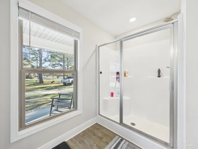 a view of a bathroom with a shower and a window