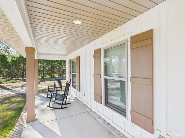 a dining room with furniture and floor to ceiling window